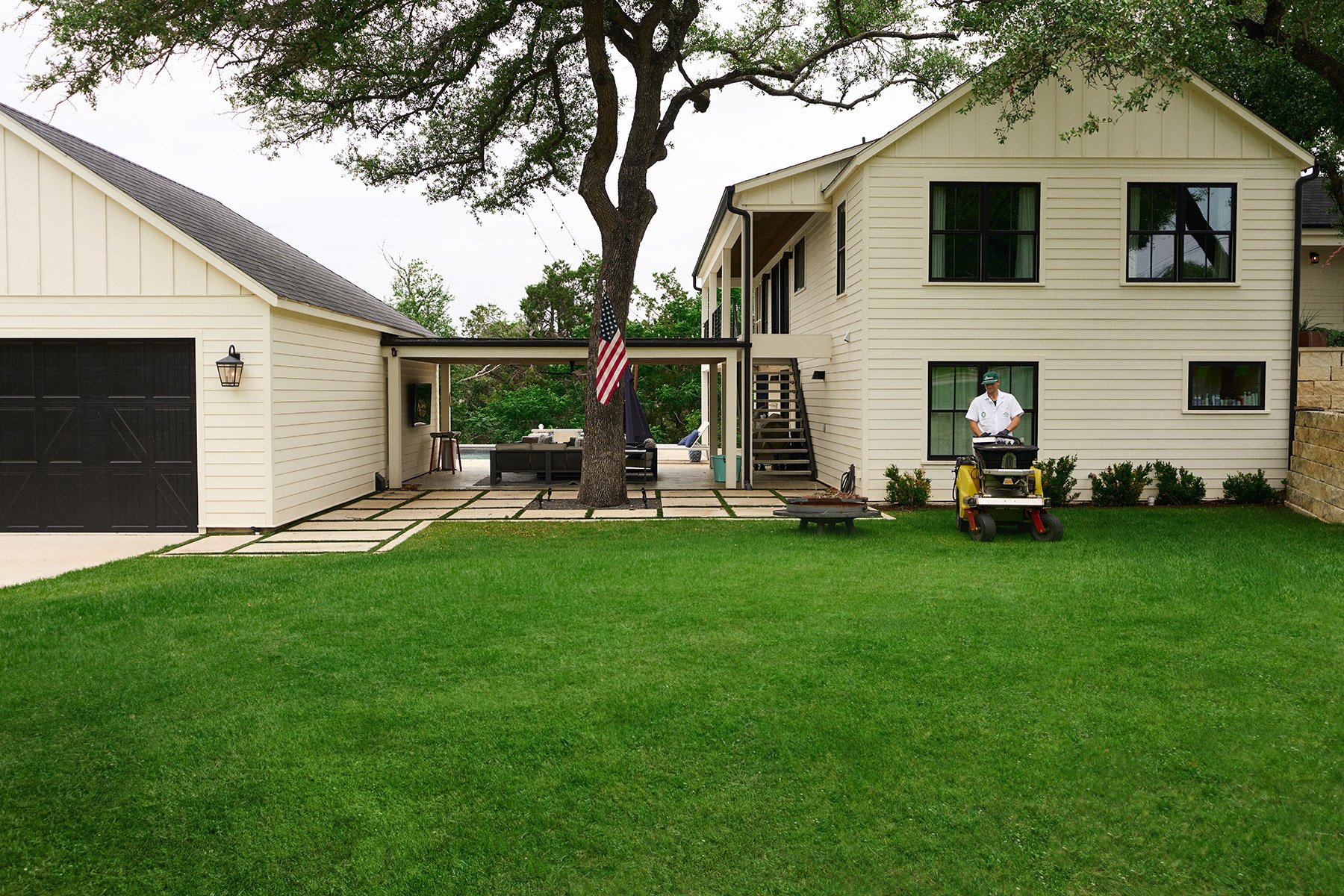 Lawn care tech applying treatment in West Austin, TX