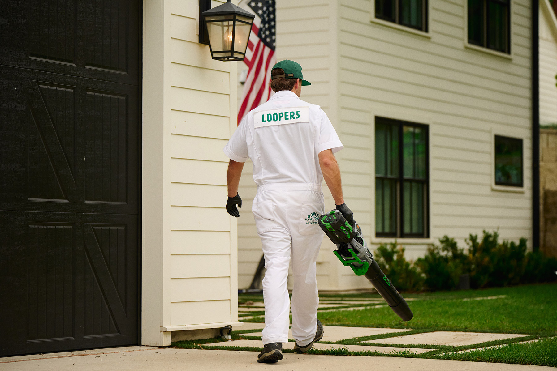 lawn care tech with blowers for cleanup